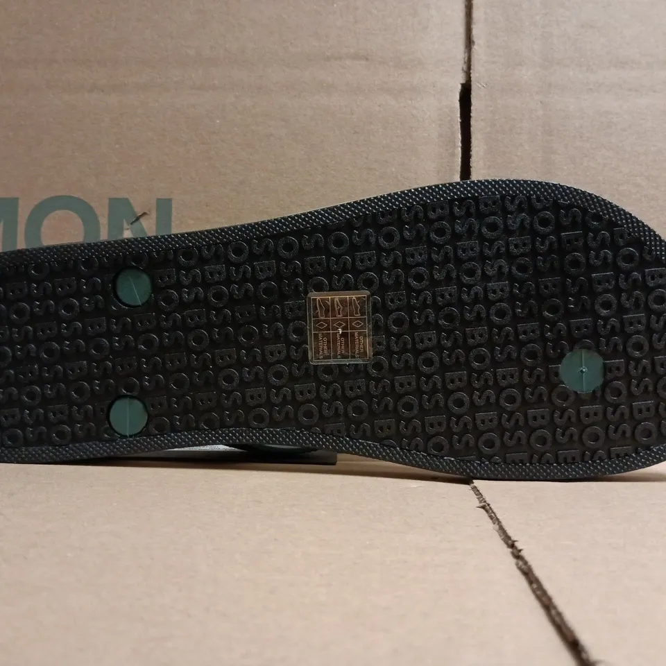 BOXED PAIR OF BOSS TRACY LOGO FLIP FLOPS IN LIGHT GREEN SIZE 7