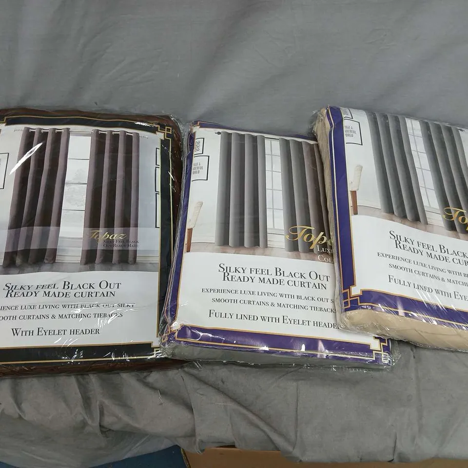 BOX OF APPROXIMATELY 6 TOPAZ BLACKOUT EYELET CURTAINS IN ASSORTED COLOURS TO INCLUDE - BEIGE - GREY - BROWN
