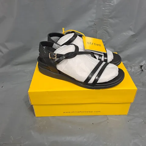 BOXED PAIR OF STRIVE ANGUILA SANDALS IN BLACK - SIZE 7