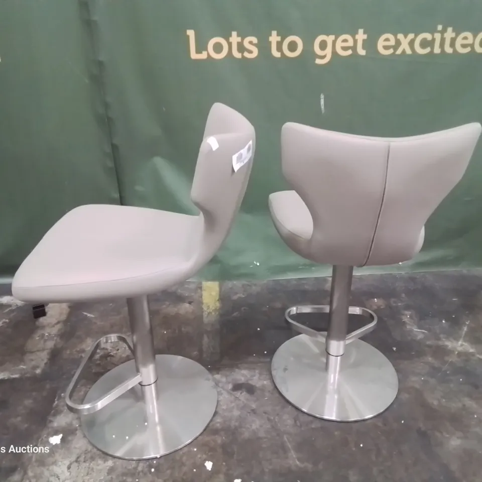 PAIR OF DESIGNER UPHOLSTERED BAR STOOLS FAWN FAUX LEATHER ON BRUSHED STEEL SUPPORT