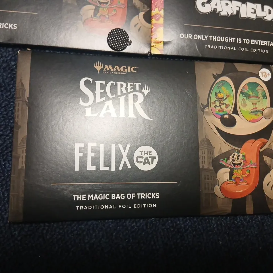 SIX ASSORTED MAGIC: THE GATHERING SECRET LAIR BOOSTERS TO INCLUDE; GARFIELD & FELIX THE CAT EACH PACK CONTAINS 5 CARDS