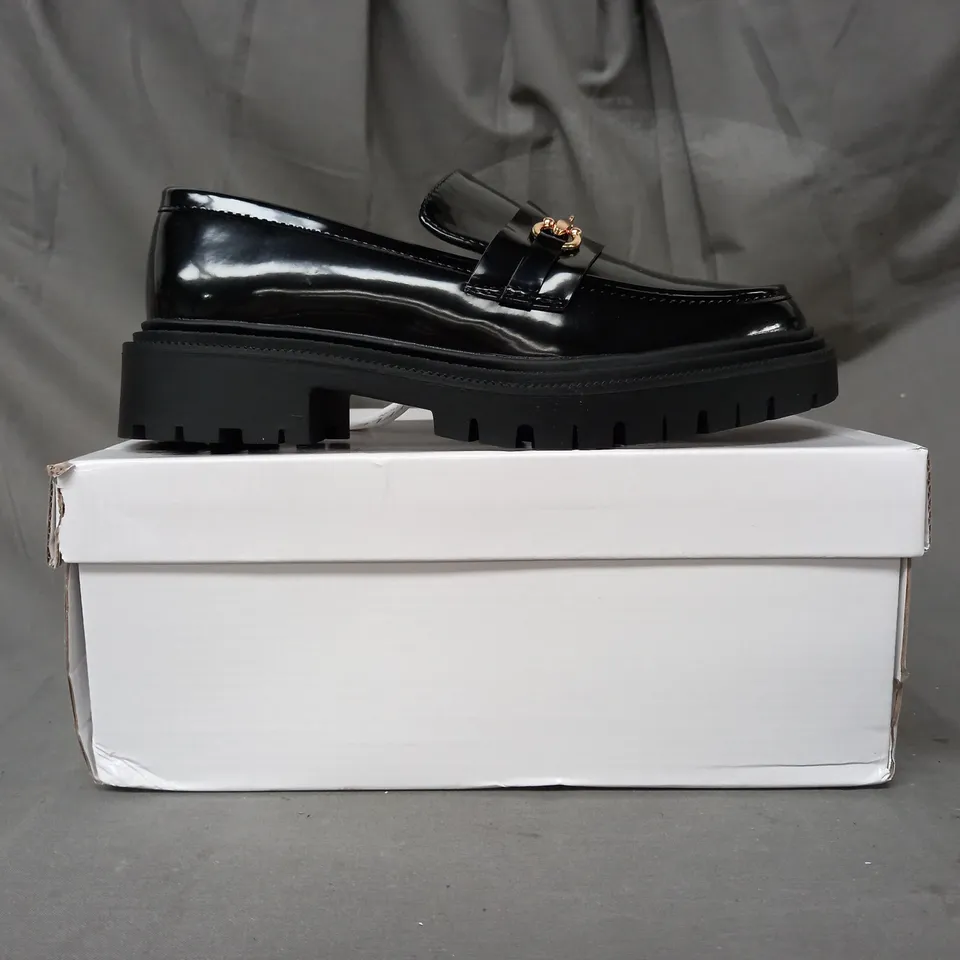 BOXED PAIR OF TRUFFLE COLLECTION LOAFERS IN GLOSSY BLACK W. GOLD EFFECT DETAIL SIZE 5