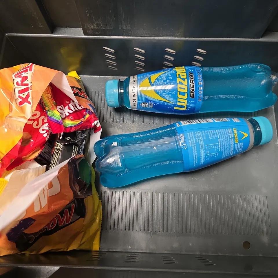 APPROXIMATELY 6 ASSORTED FOOD & DRINK ITEMS TO INCLUDE - HARIBO PARTY BOX , FREE SOUL  12 VEGAN PROTEIN BARS , LUCOZADE BLUE BURST ETC
