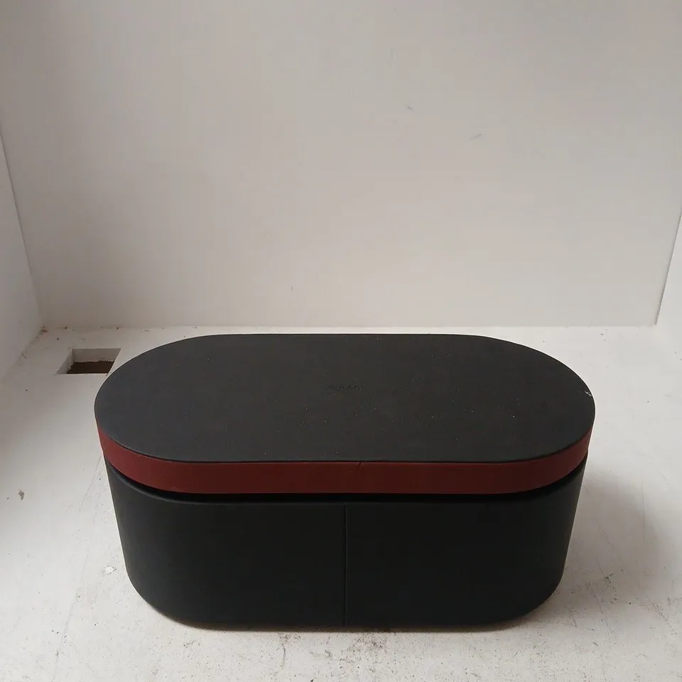 DYSON NURAL WITH OVAL BLACK STORAGE OTTOMAN WITH RED TRIM