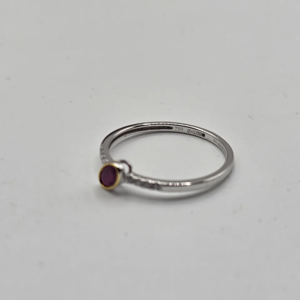 18CT GOLD RING WITH AN OFFSET OVAL CUT RUBY & NATURAL DIAMONDS TO THE SHOULDER