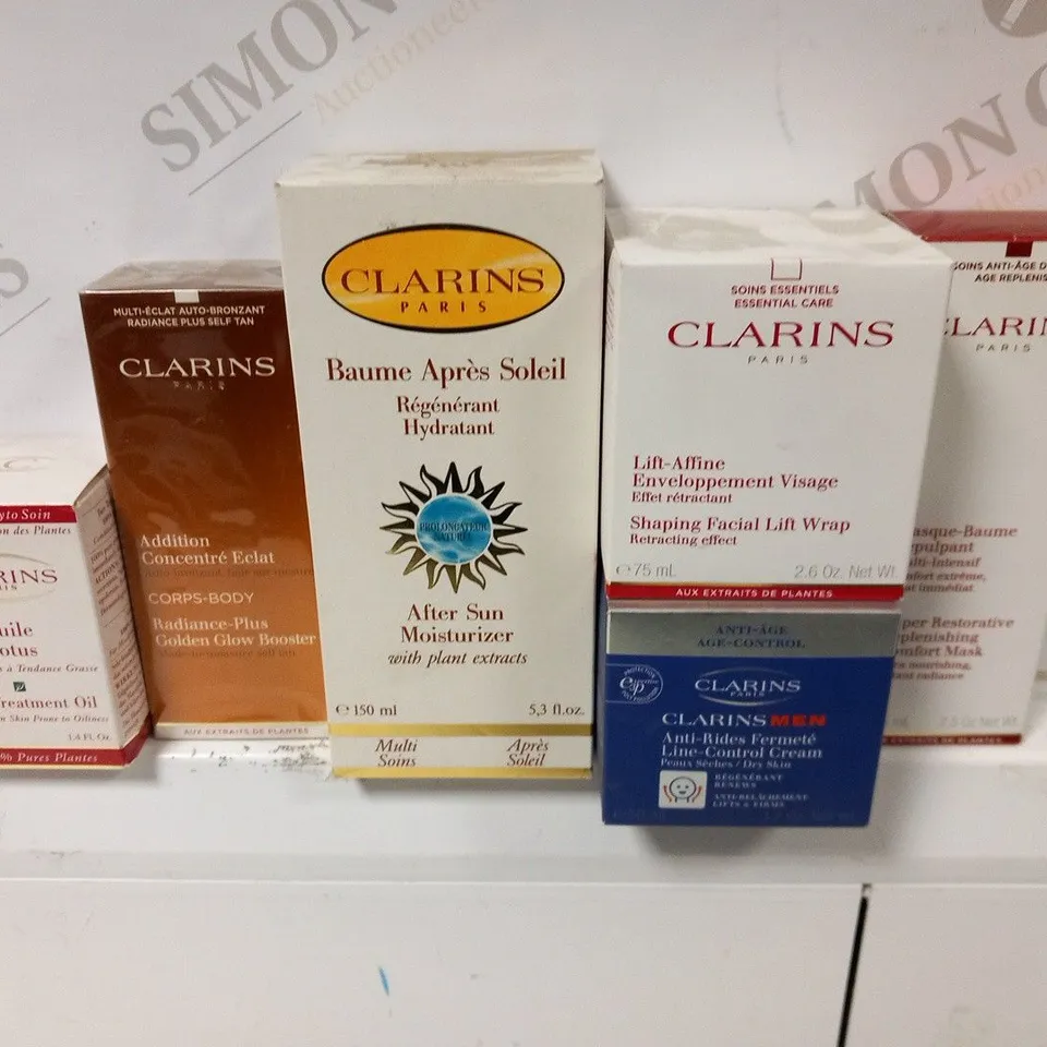 APPROXIMATELY 28 ASSORTED CLARINS PARIS COSMETICS PRODUCTS TO INCLUDE; FACE TREATMENT IL, RADIANCE PLUS GOLDEN GLOW BOOSTER, AFTER SUN MOISTURIZER AND LINE CONTROL CREAM