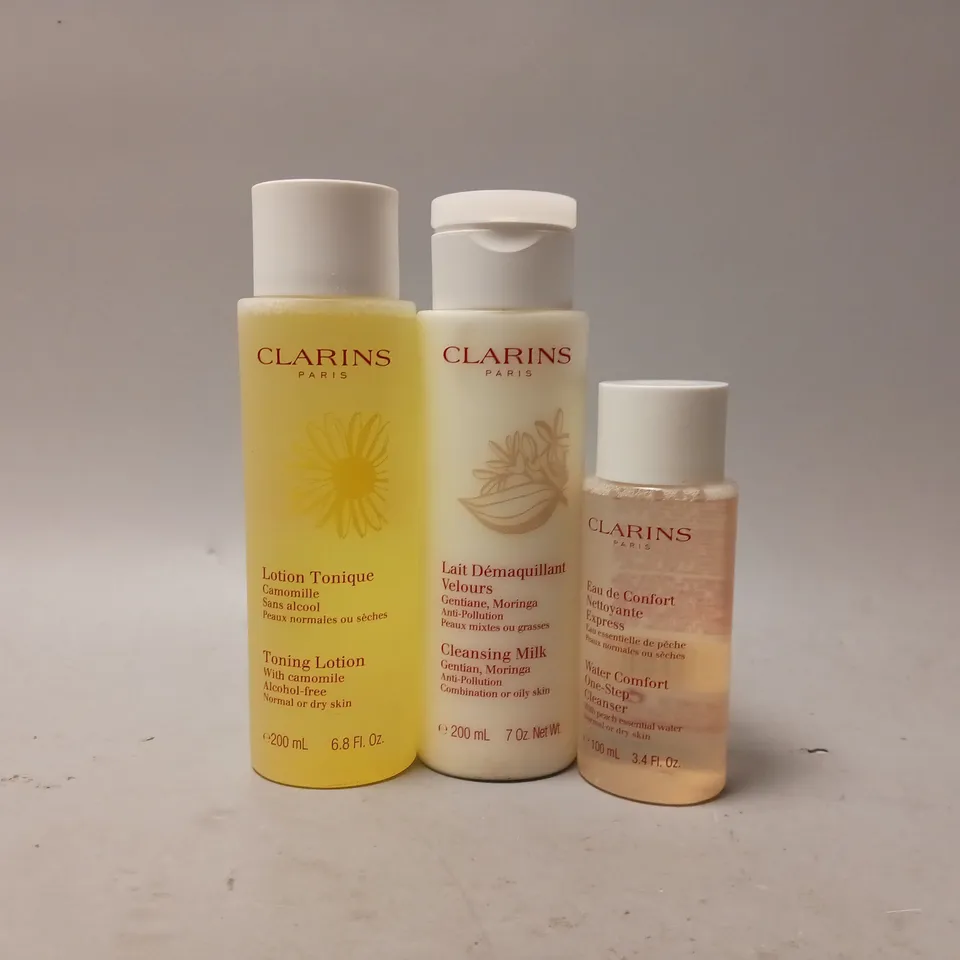 3 ASSORTED CLARINS BEAUTY PRODUCTS TO INCLUDE TONING LOTION, CLEANSING MILK, WATER COMFORT ONE-STEP CLEANSER 