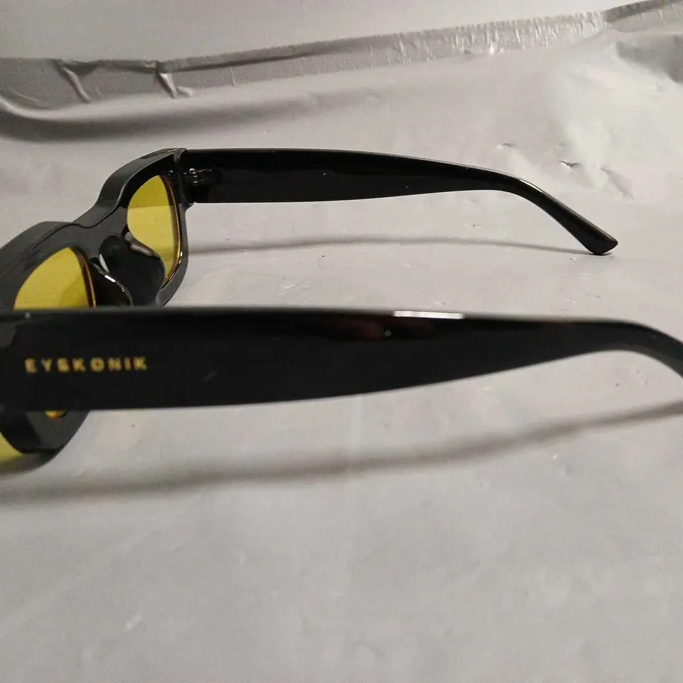 BOXED PAIR OF EYEKONIK BLACK FRAMED GLASSES WITH YELLOW TINT LENS