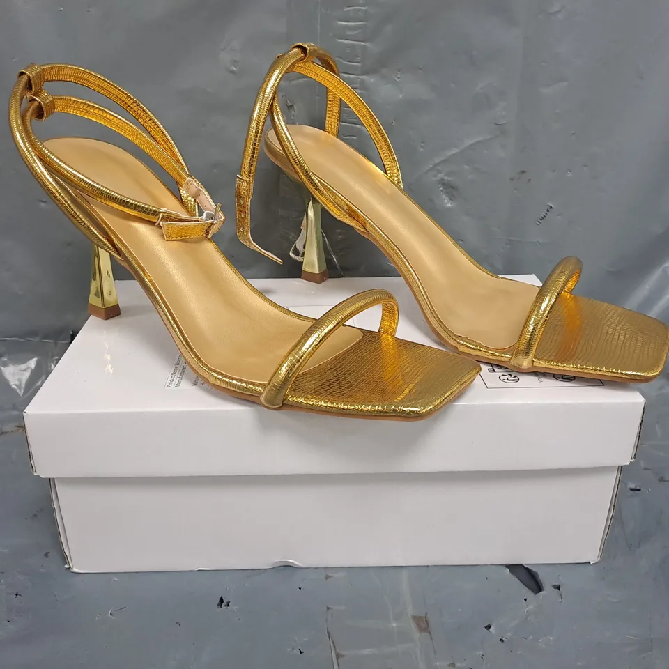BOXED PAIR OF UNBRANDED OPEN TOE STRAPPY HEELED SANDALS IN METALLIC GOLD SIZE EU 42