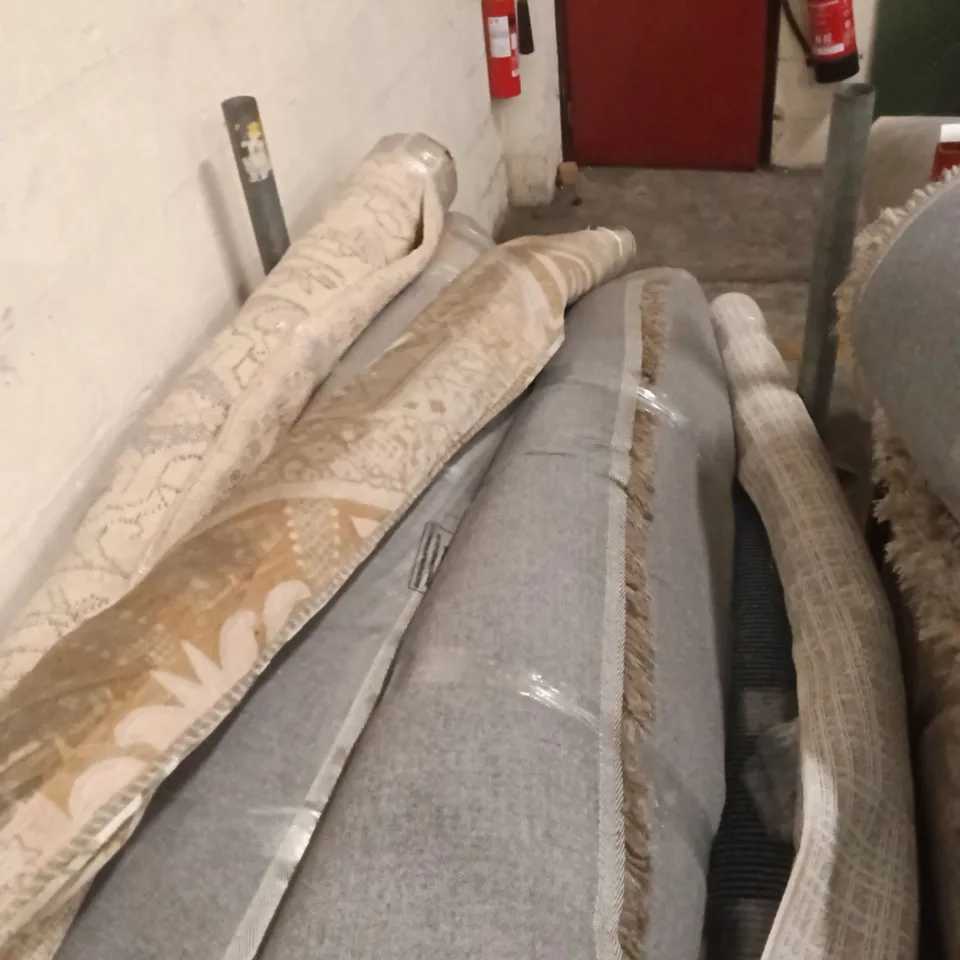 STILLAGE CONTAINING DESIGNER AREA RUGS APPROXIMATELY 15 RUGS 