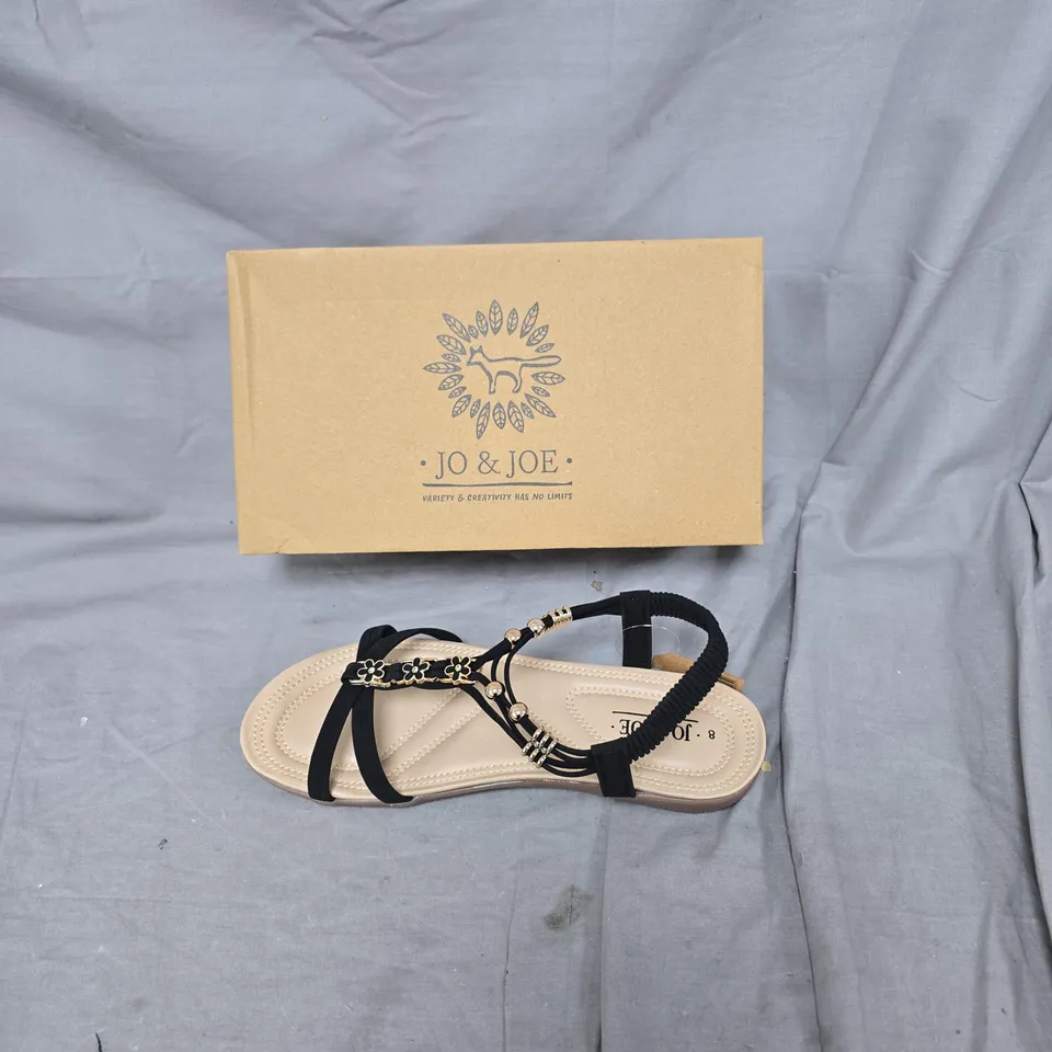 JO & JOE WOMEN’S SANDALS – BLACK STRAPS WITH FLORAL EMBELLISHMENTS – UK 8