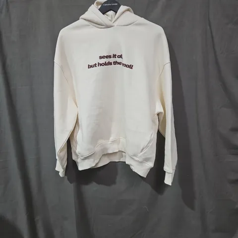 CREAM HOODIE WITH BACK GRAPHIC AND FRONT TEXT – NOT EVERY MOMENT NEEDS A PURPOSE SIZE MEDIUM 