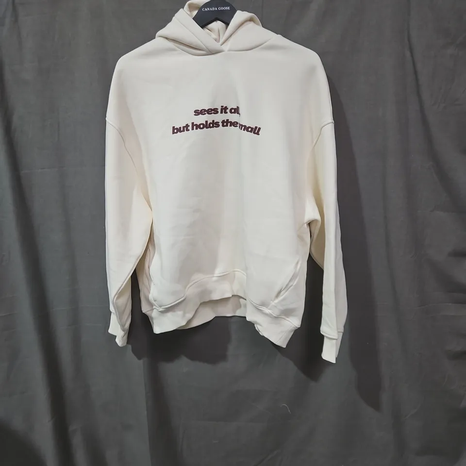 CREAM HOODIE WITH BACK GRAPHIC AND FRONT TEXT – NOT EVERY MOMENT NEEDS A PURPOSE SIZE MEDIUM 