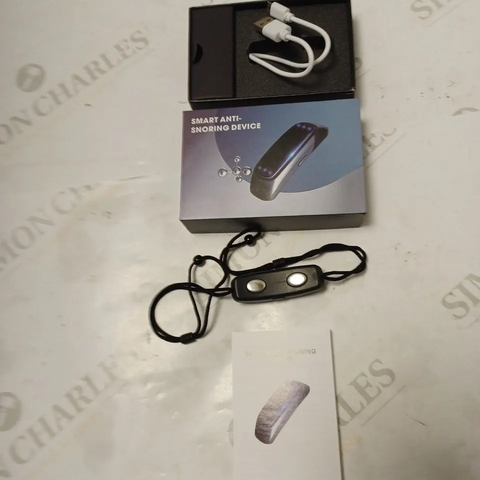 BOXED SMART ANTI-SNORING DEVICE WITH USB CABLE AND INSTRUCTIONS
