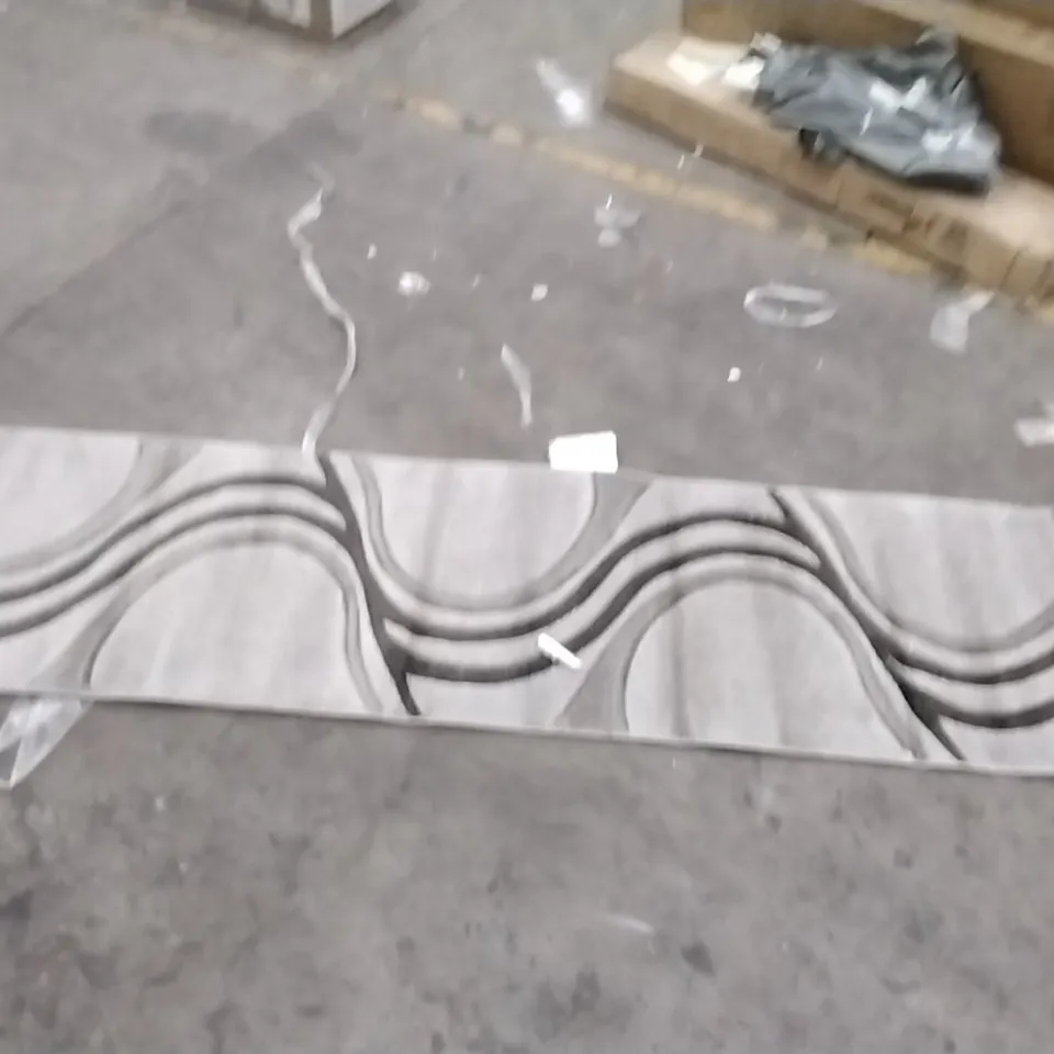 STILLAGE OF APPROXIMATELY 12 DESIGNER RUGS
