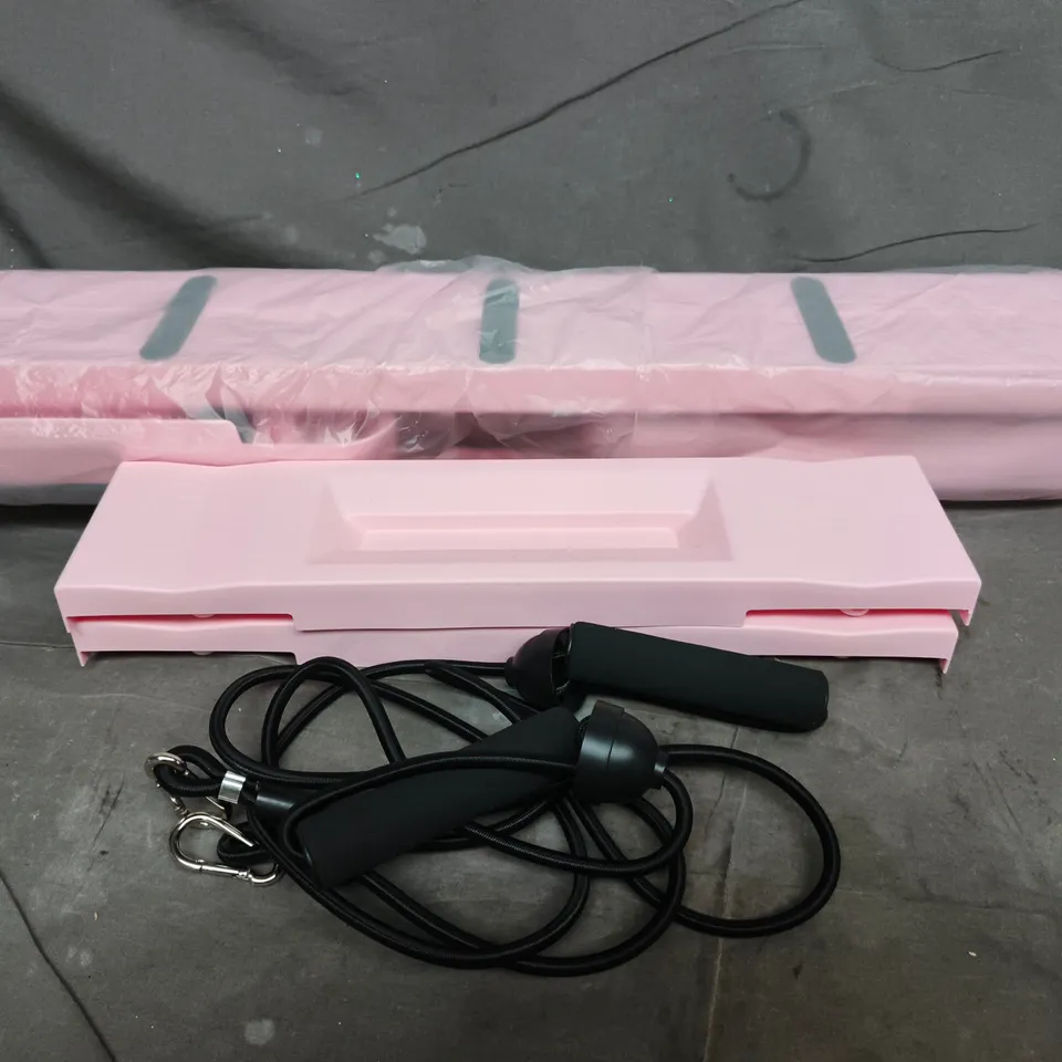 PINK PLASTIC HANDHELD FITNESS ACCESSORY WITH CORDS