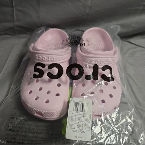 PAIR OF CROCS CLASSIC CLOGS IN PALE PINK SIZE UK M4/W5