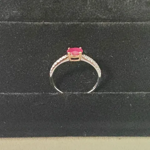 18CT GOLD RING SET WITH AN OVAL CUT RUBY AND DIAMONDS TO EACH SHOULDER WEIGHING +-0.66CT