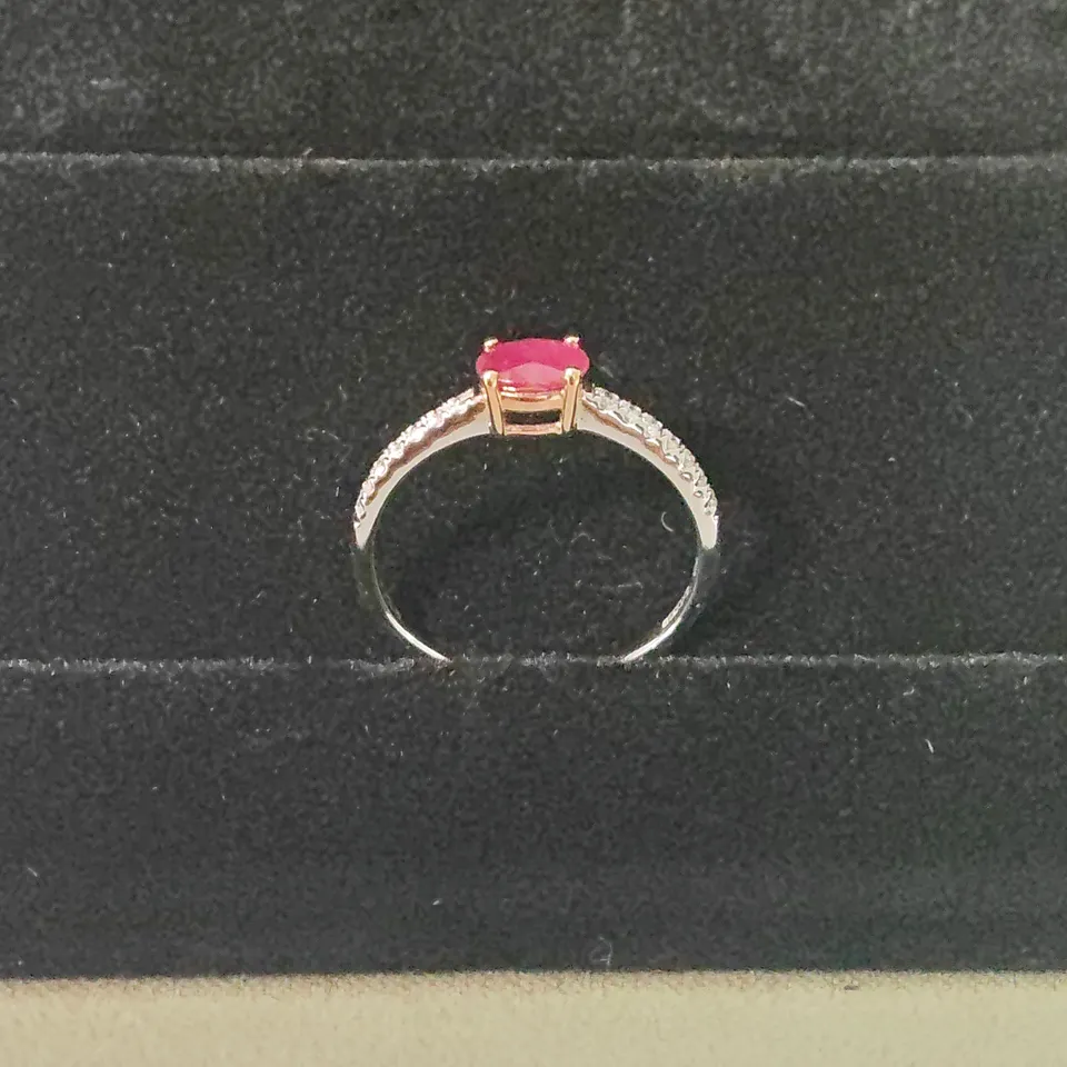 18CT GOLD RING SET WITH AN OVAL CUT RUBY AND DIAMONDS TO EACH SHOULDER WEIGHING +-0.66CT