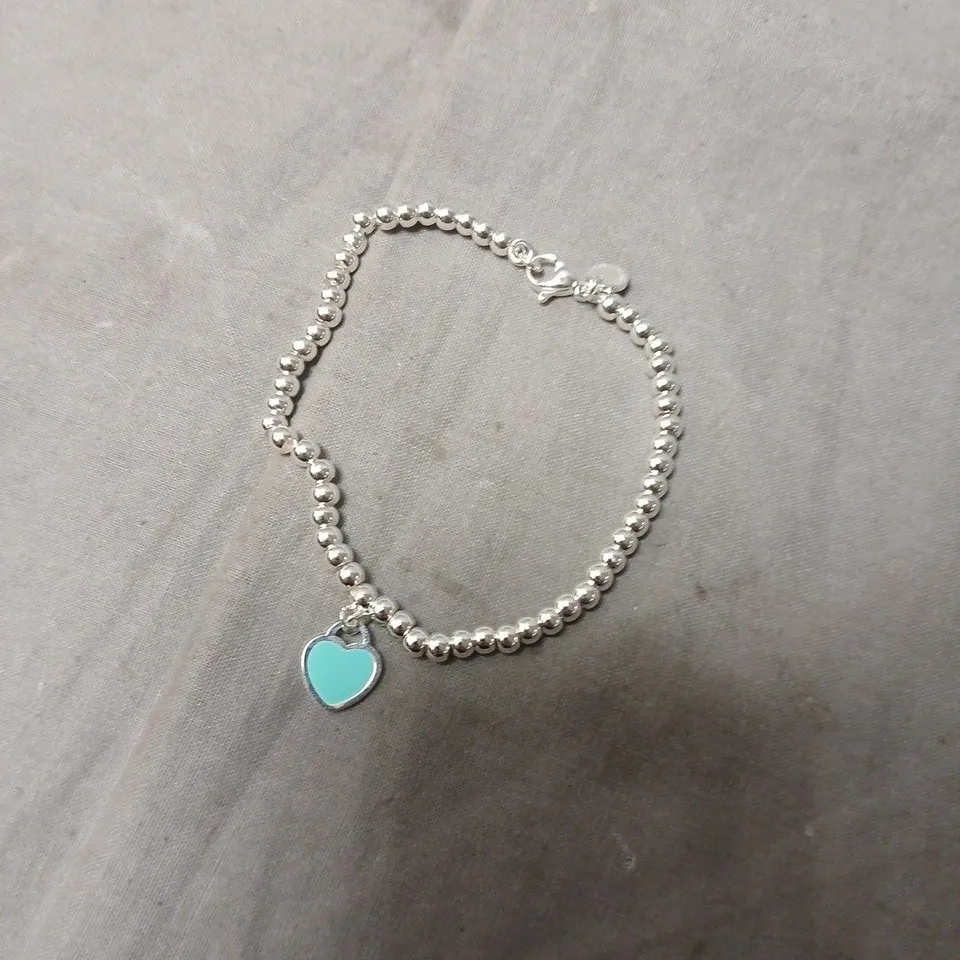 TIFFANY & CO. SILVER BEAD BRACELET WITH TURQUOISE HEART CHARM