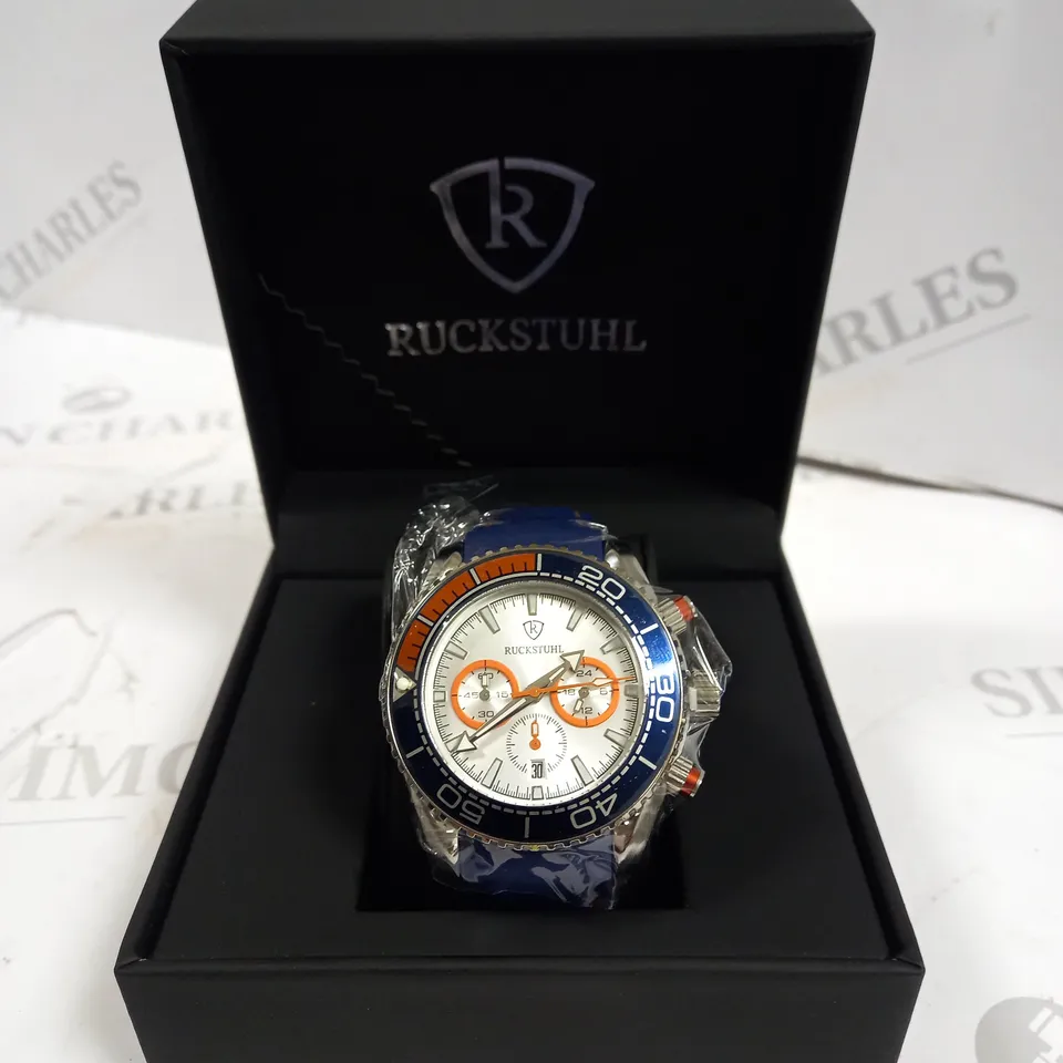 MEN’S RUCKSTUHL CHRONOGRAPH R400 WATCH – SILVER COLOUR CASE – SILVER DIAL – 3ATM WATER RESISTANT – BLUE RUBBER STRAP