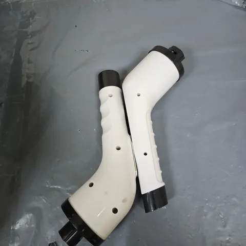 PAIR OF WHITE PLASTIC ERGONOMIC HANDLES WITH BLACK END CAPS – UNIDENTIFIED T