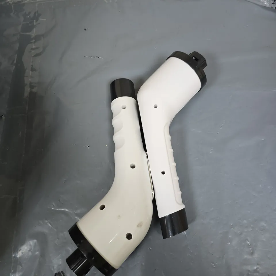 PAIR OF WHITE PLASTIC ERGONOMIC HANDLES WITH BLACK END CAPS – UNIDENTIFIED T