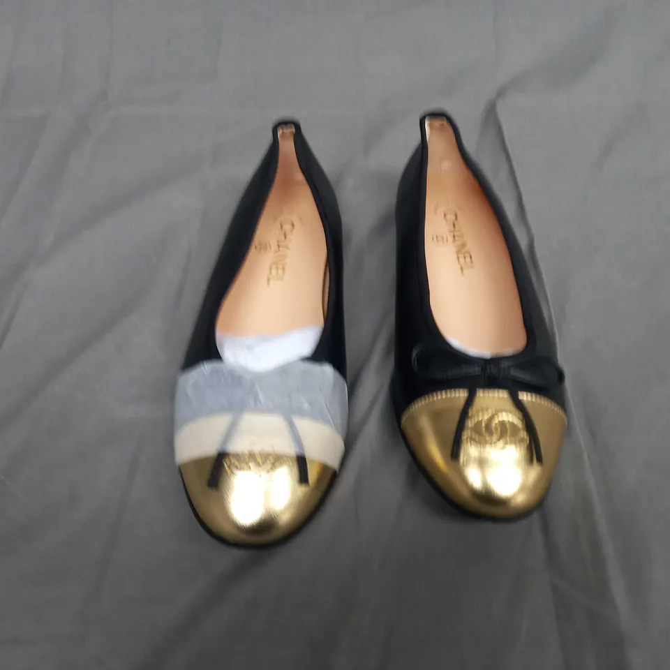 UNBOXED PAIR OF CHANEL SIZE 37C SLIP ON PUMPS IN BLACK/GOLD