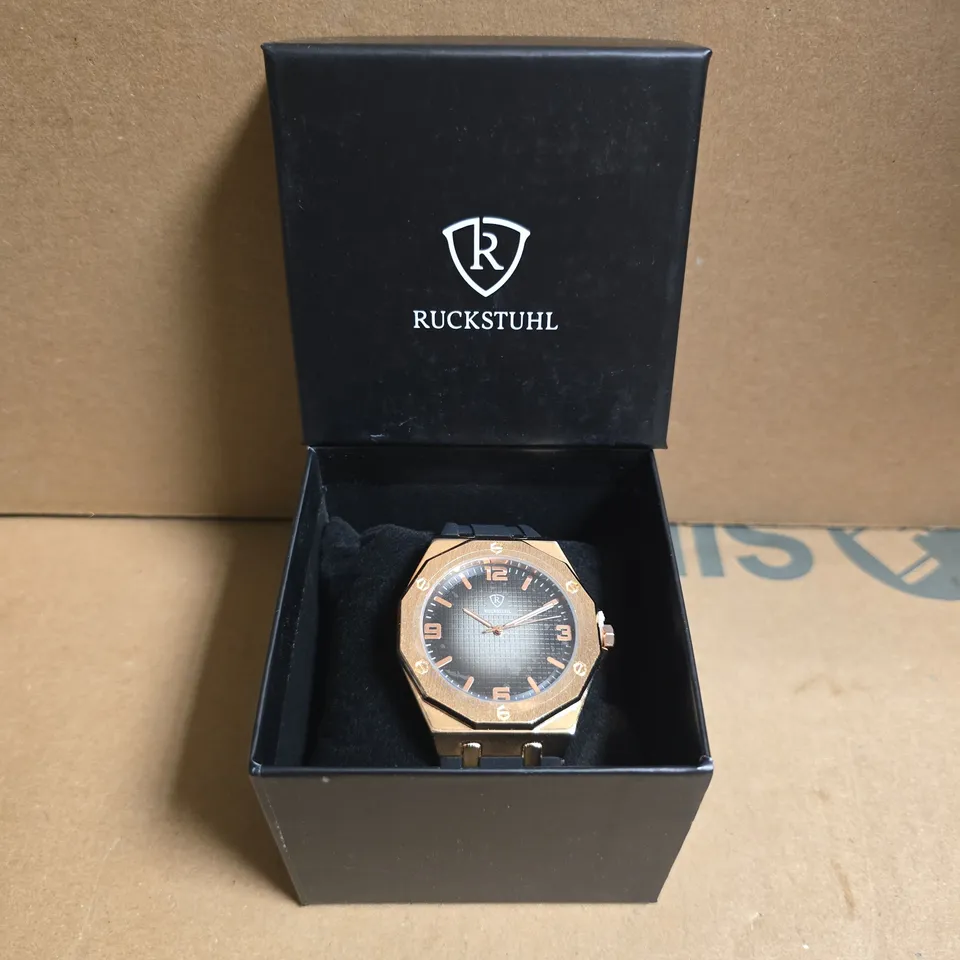 RUCKSTUHL BLACK RUBBER STRAP WRISTWATCH WITH ROSE GOLD COLOUR FRAME AND BLACK/SILVER COLOUR FACE