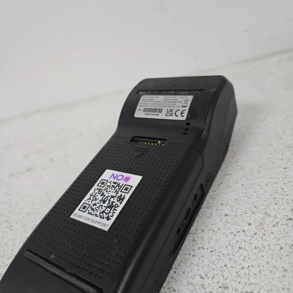 BLACK HANDHELD CARD MACHINE – APPEARS TO BE A DOCKING CRADLE OR ADAPTER
