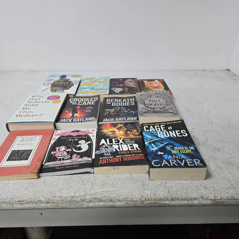 CAGE CONTAINING A LARGE QUANTITY OF ASSORTED BOOKS INCLUDING RULE OF WOLVES , CAGE OF BONES , ALEX RIDERR EAGLE STRIKE AND GURKHA