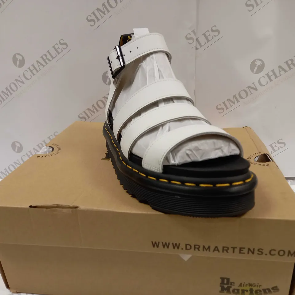 boxed pair of dr martens blaire hydro leather strap sandals 