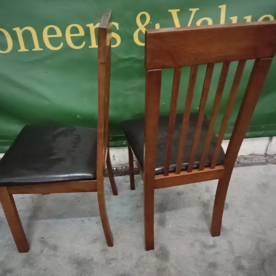 PAIR OF WOODEN DINING CHAIRS WITH BLACK FAUX LEATHER SEAT PADS 