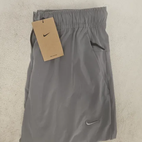 NIKE UNLIMITED STANDARD FIT PANTS IN GREY SIZE SMALL