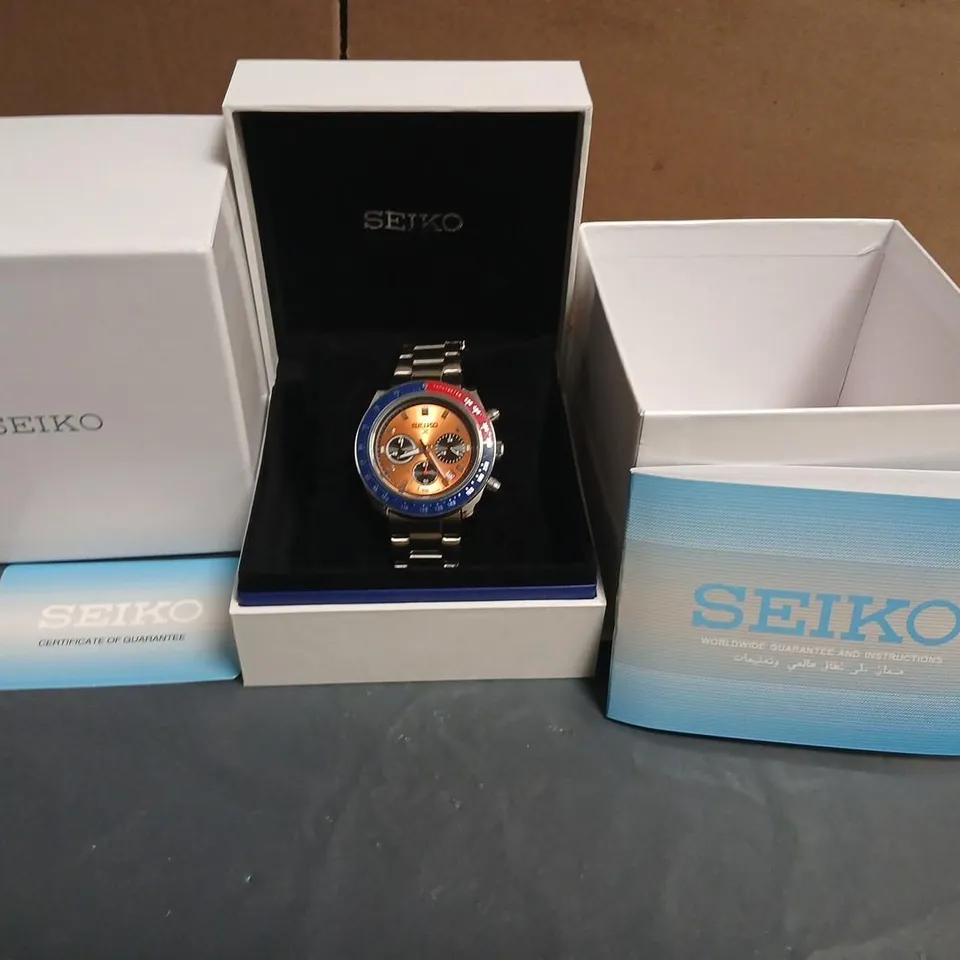 SEIKO CHRONOGRAPH WATCH, STAINLESS STEEL BRACELET, ORANGE DIAL WITH BLUE TACHYMETER BEZEL – BOXED