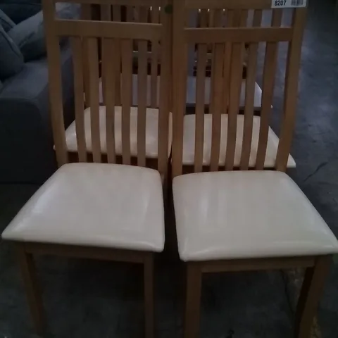 APPROXIMATELY 4 OAK EFFECT SLATTED BACK DINING CHAIRS WITH CREAM FAUX LEATHER SEAT PADS