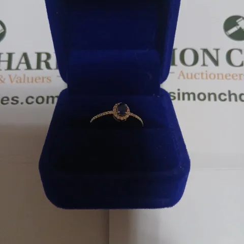 18CT WHITE GOLD RING WITH AN OVAL SHAPE SAPPHIRE AND NATURAL DIAMOND HALO AND SHOULDERS