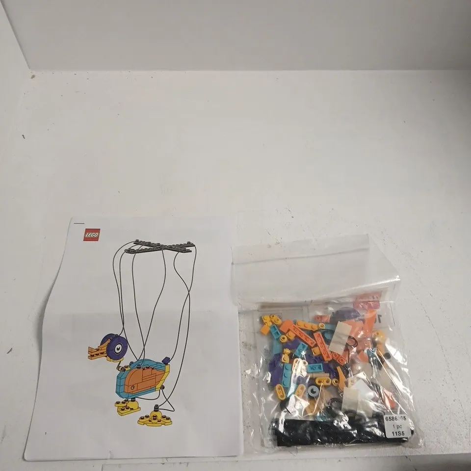 LEGO DUCK MARIONETTE SET WITH INSTRUCTION SHEET AND SEALED BRICK BAG