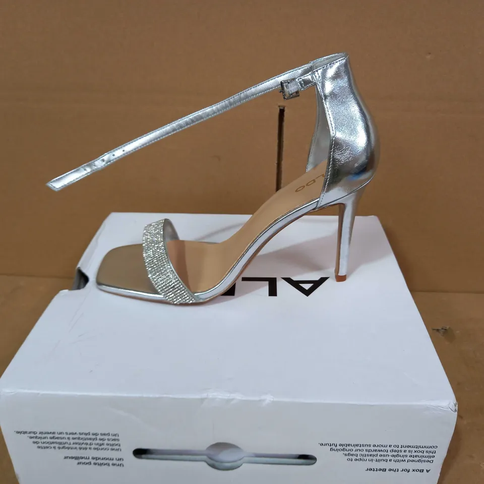 BOXED PAIR OF ALDO HEELS IN SILVER COLOUR WITH JEWEL EFFECT UK SIZE 7
