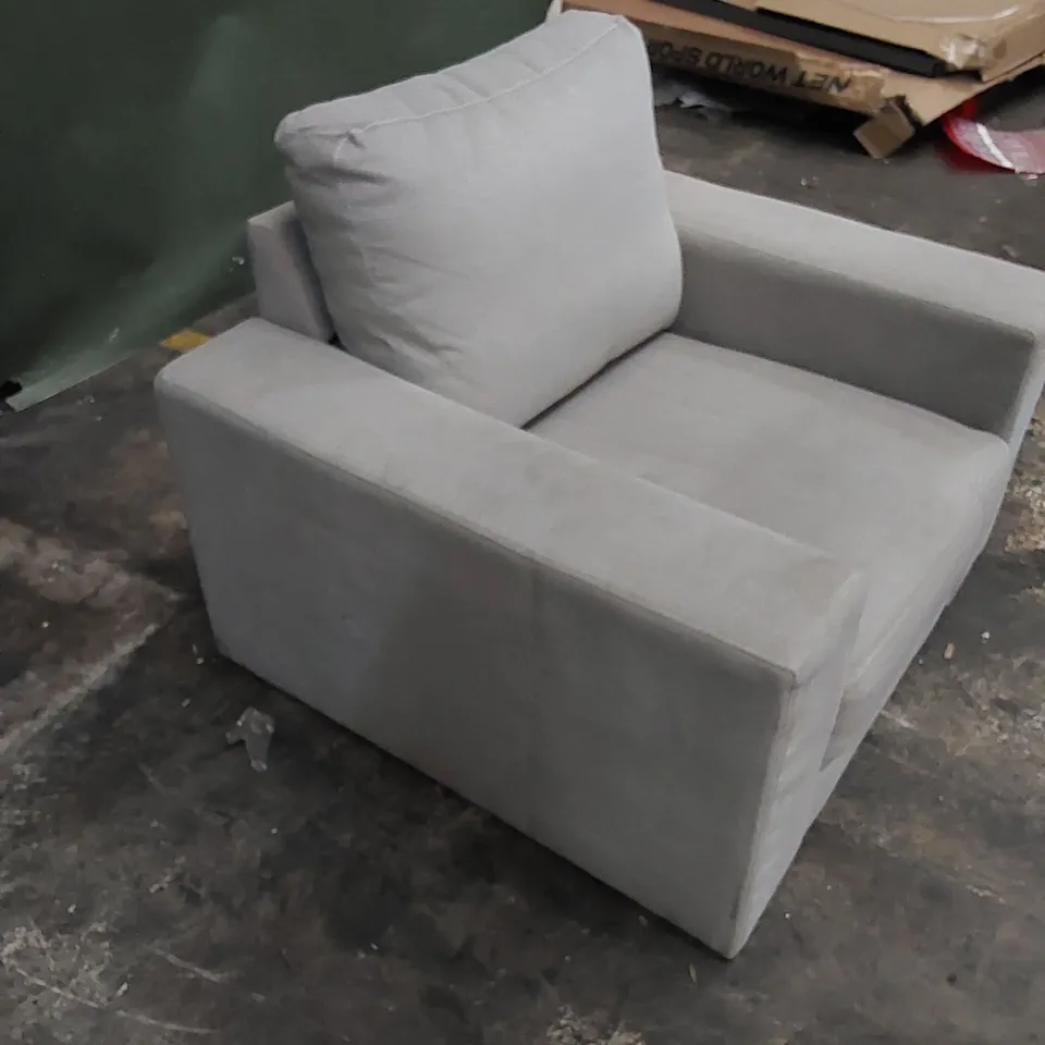 DESIGNER ARMCHAIR HOLSTERED IN A LIGHT COLOURED FABRIC 