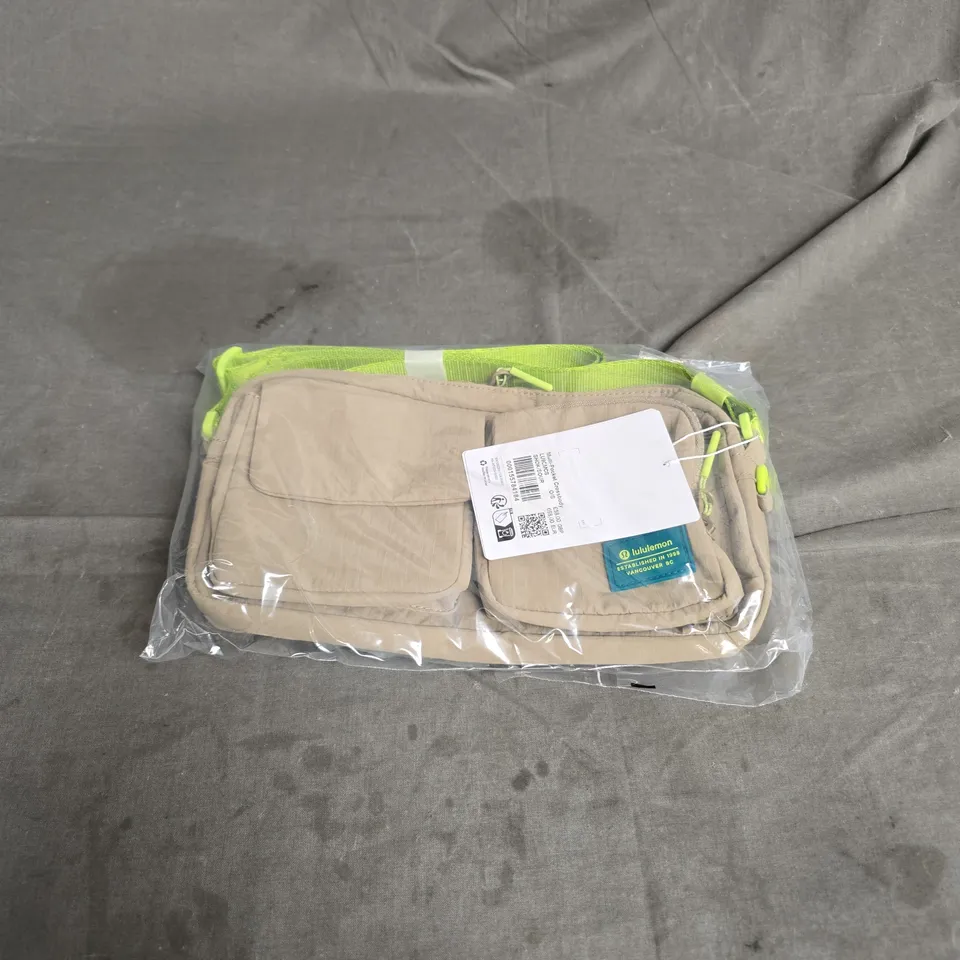 LULULEMON MULTI-POCKET CROSSBODY BAG IN SHEER OAK/SOUR GREEN ONE SIZE