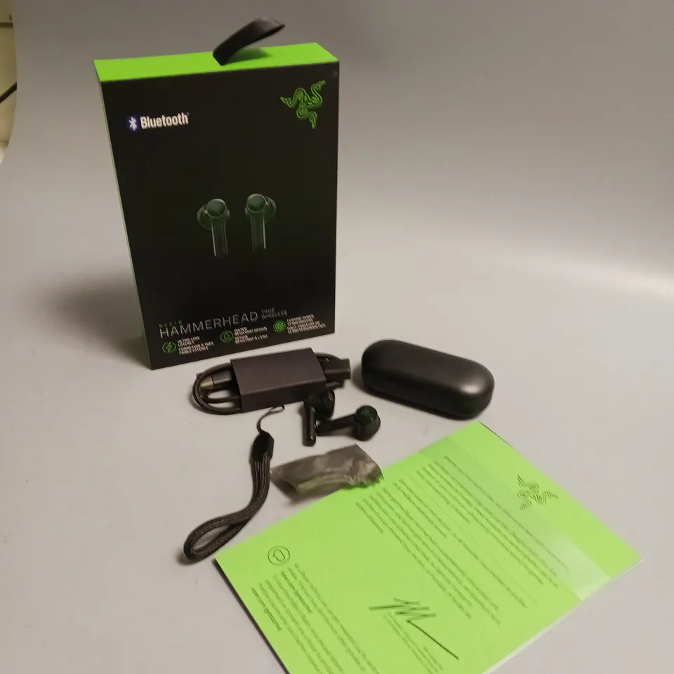 LOT OF 5 BOXED RAZER WIRELESS HEADPHONES IN BLACK AND GREEN INCLUDES CHARGING CASE, CABLE, WRIST STRAP AND SPARE BUDS