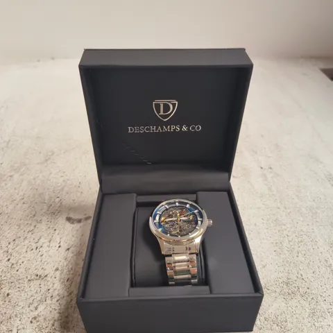 WRISTWATCH WITH SKELETON DIAL IN DESCHAMPS & CO PRESENTATION BOX, STAINLESS STEEL BRACELET