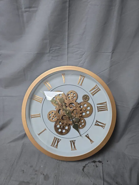 Lot 1216: ROUND GOLD-TONE WALL CLOCK WITH EXPOSED GEAR MECHANISM AND ...
