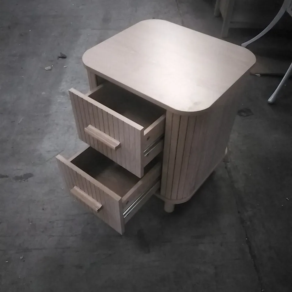 SUIRE LIGHT WOOD BEDSIDE TABLE, FEATURING ROUNDED CORNERS AND FLUTED DRAWER FRONTS