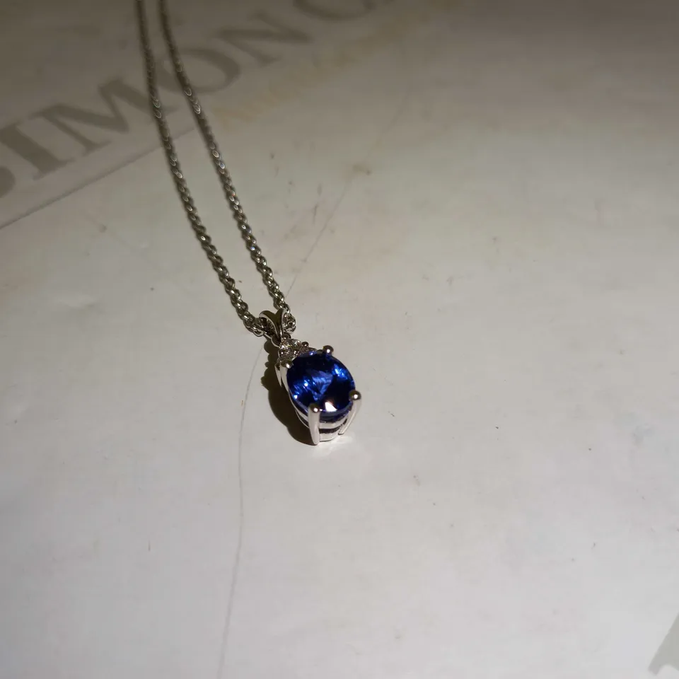 DESIGNER 18CT WHITE GOLD PENDANT ON A CHAIN, SET WITH AN OVAL CUT TANZANITE AND DIAMONDS WEIGHING +-2.67CT