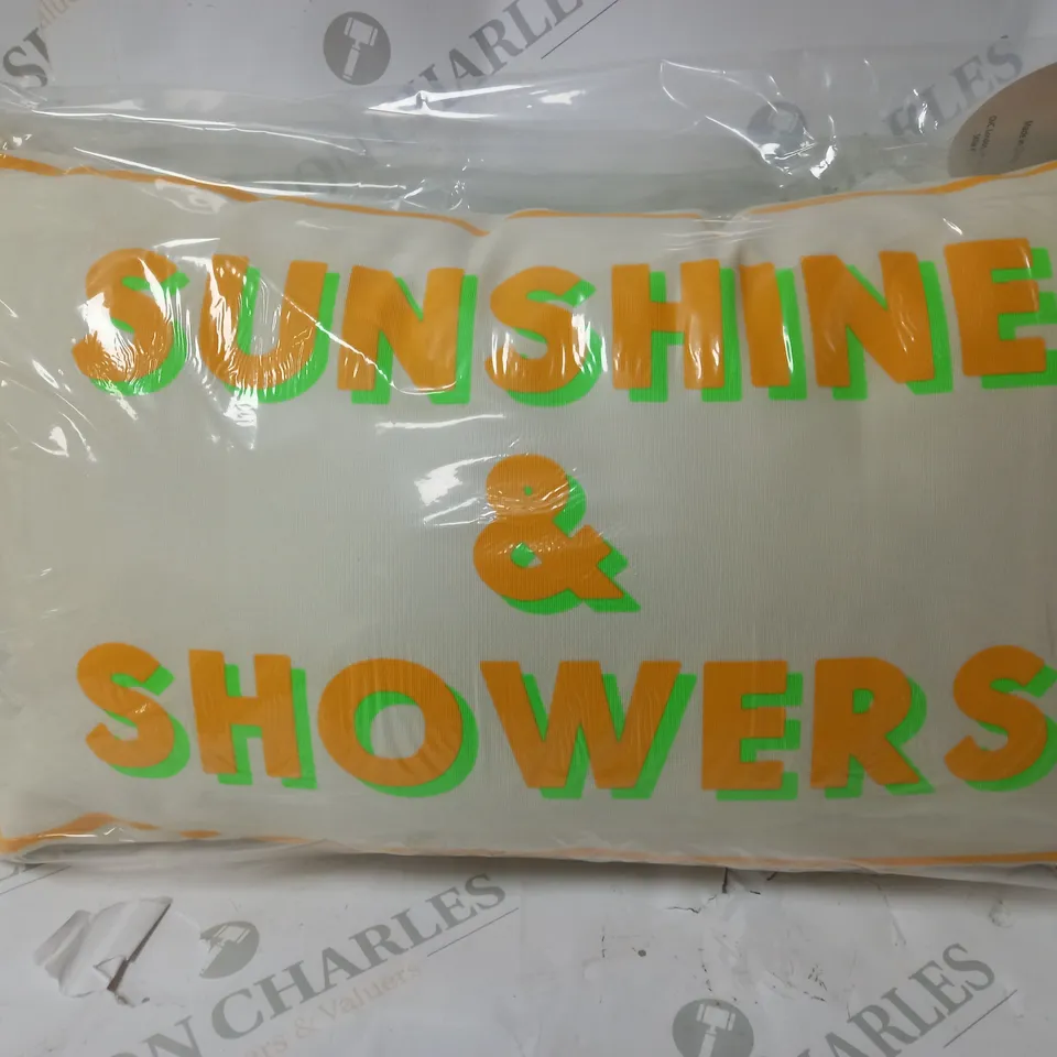 CREAM CUSHION WITH NEON WRITING
