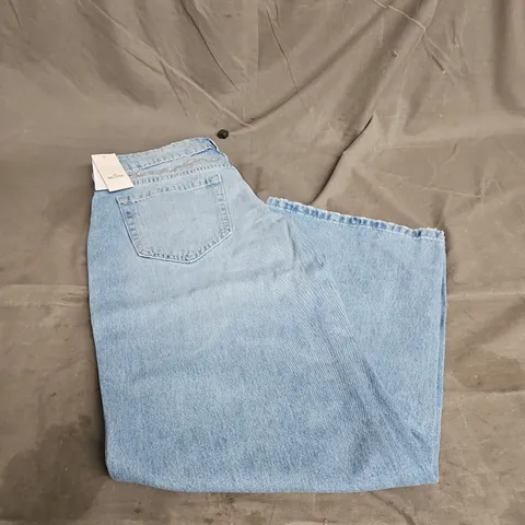 HOLLISTER BAGGY LOW RISE JEANS IN BLUE SENIM WITH FLORAL EMBROIDERY SIZE W25 SHORT