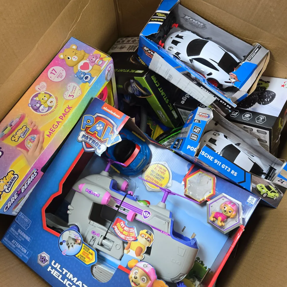 APPROXIMATELY 15 ASSORTED TOYS & GAMES PRODUCTS TO INCLUDE PAW PATROL ULTIMATE HELICOPTER, CARE BEARS SHAKER MAKER MEGA PACK, PORSCHE RC CAR, ETC