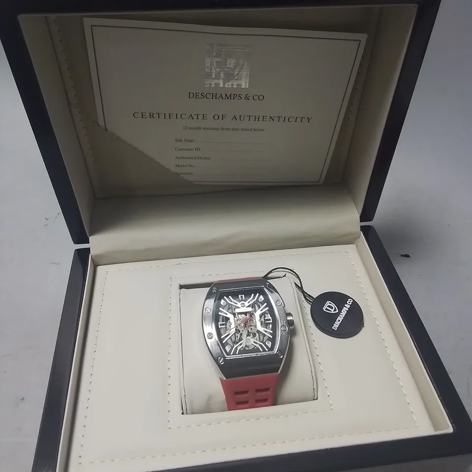 DESCHAMPS & CO STAINLESS STEEL SKELETON DIAL GENTS WATCH WITH AUTOMATIC MOVEMENT AND RED RUBBER STRAP IN WOODEN GIFT BOX